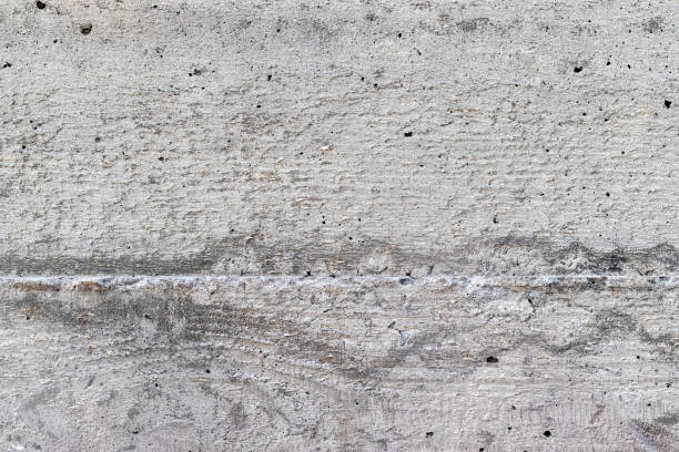 istock Gray, rough, concrete background texture. Wall with holes and various splashes 1209063625