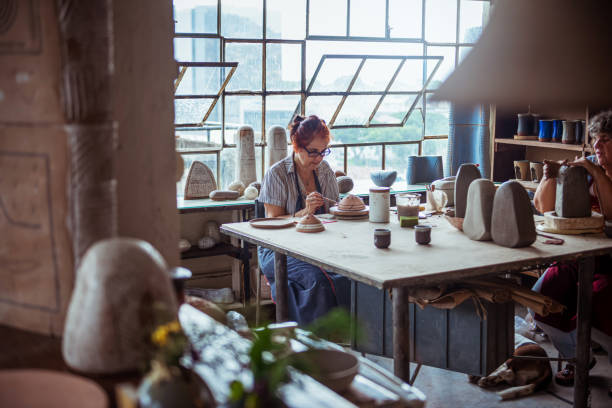 istock Women making pottery indoors 1209066339