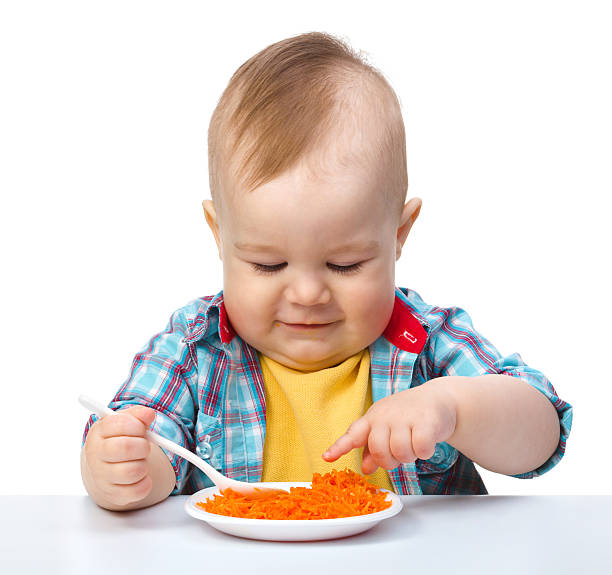 istock Cute little boy is playing with carrot salad 120906746