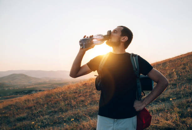 istock Tourist drinks water from a bottle 1209071614