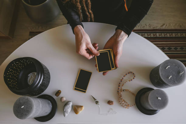 istock stack of fortune telling cards and a woman's hands on a white table 1209073324