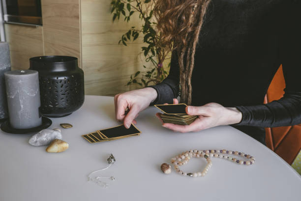 istock stack of fortune telling cards and a woman's hands on a white table 1209073470