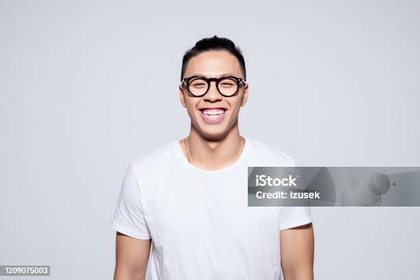 Cheerful Asian Young Man Laughing At Camera Stock Photo - Download Image Now - Asian and Indian Ethnicities, Men, Smiling