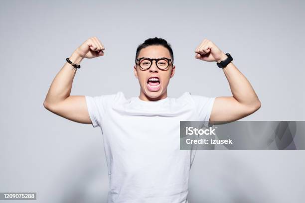 Excited Asian Winner Stock Photo - Download Image Now - Shouting, Hipster Culture, Looking At Camera