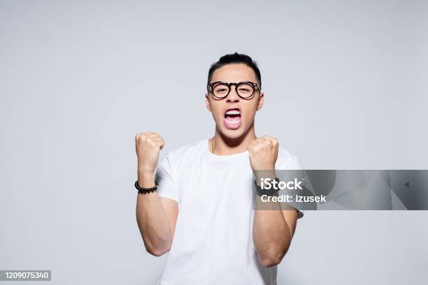 Excited Asian Winner Stock Photo - Download Image Now - Men, Asian and Indian Ethnicities, Shouting