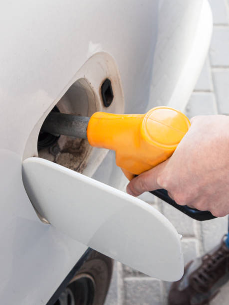 istock Refueling white car at the refuel station. 1209075410