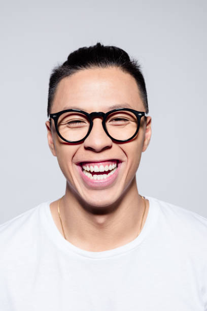 istock Excited asian young man laughing at camera 1209075447
