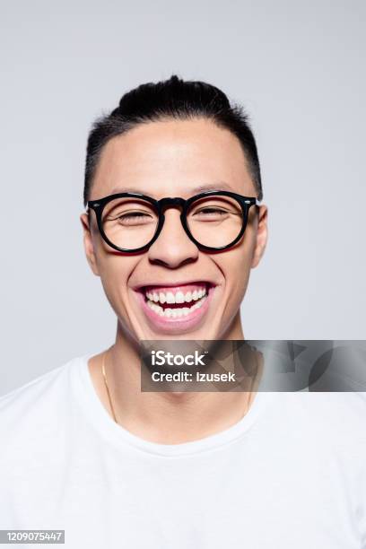 Excited Asian Young Man Laughing At Camera Stock Photo - Download Image Now - Hipster Culture, Young Adult, 20-24 Years