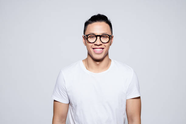 istock Friendly asian young man smiling at camera 1209076241