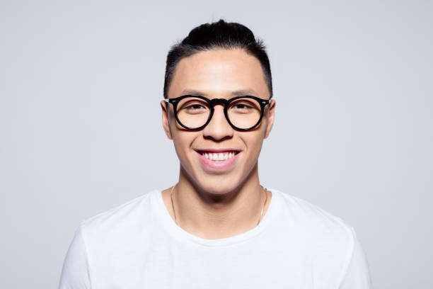 istock Friendly asian young man smiling at camera 1209076319
