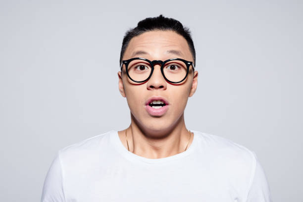 istock Headshot of surprised asian young man 1209077005