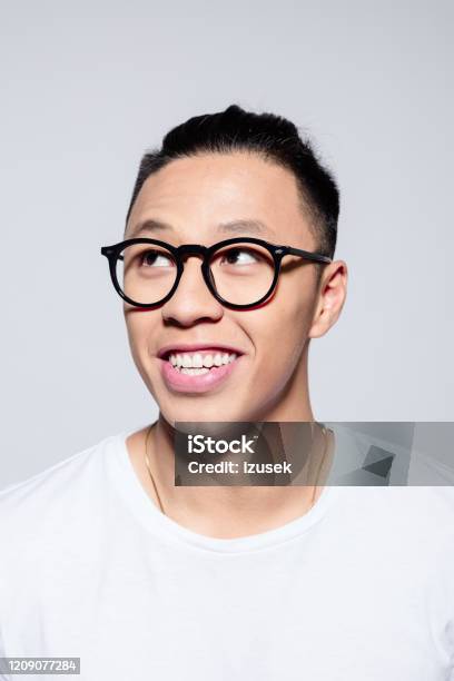 Portrait Of Cheerful Asian Young Man Stock Photo - Download Image Now - Headshot, Laughing, Nerd