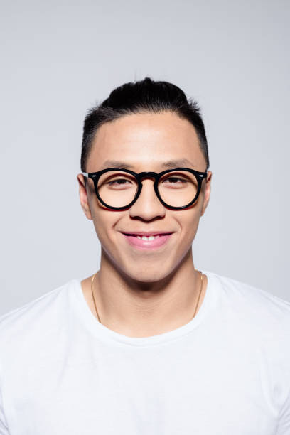istock Portrait of friendly asian young man smiling at camera 1209078062