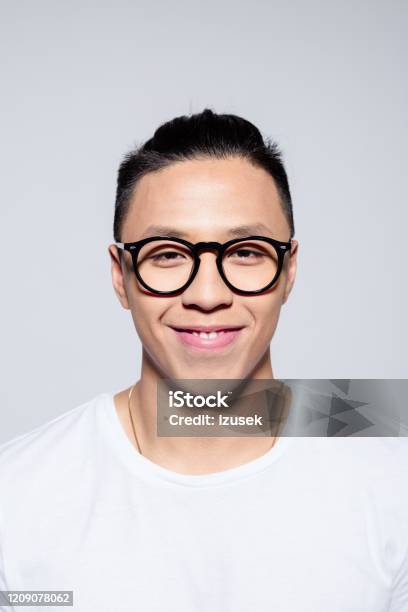 Portrait Of Friendly Asian Young Man Smiling At Camera Stock Photo - Download Image Now