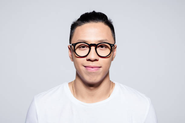 istock Portrait of friendly asian young man smiling at camera 1209078131