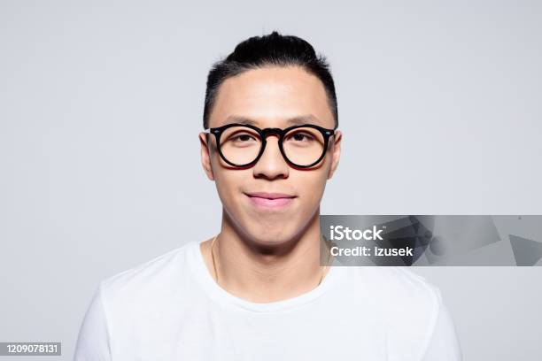 Portrait Of Friendly Asian Young Man Smiling At Camera Stock Photo - Download Image Now