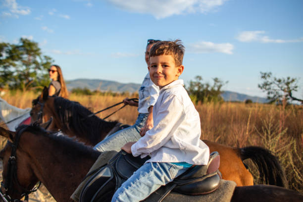 istock Smiling child enjoying a horseback ride in nature 1209078191