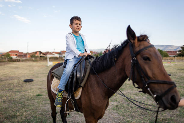 istock Horseback riding child on a ranch 1209078220