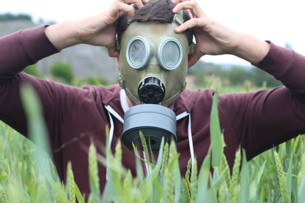 istock Terrified man wearing retro gas mask 1209078225