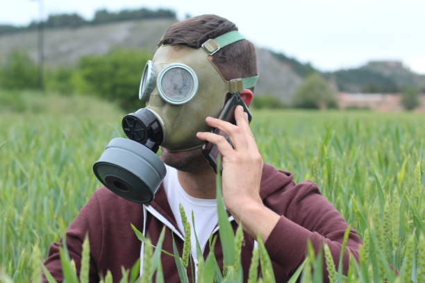 istock Man wearing gas mask calling by phone 1209078239