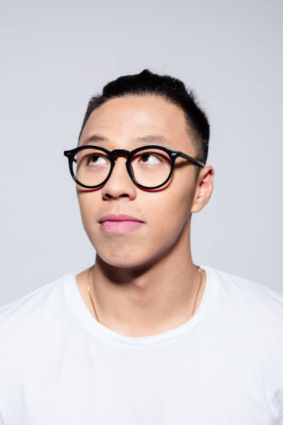 istock Portrait of pensive asian young man 1209078251