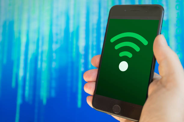 istock Hand holding cellphone with connection to WiFi 1209078997