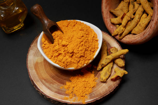 istock Indian Turmeric Roots and Ground to Powder 1209080134