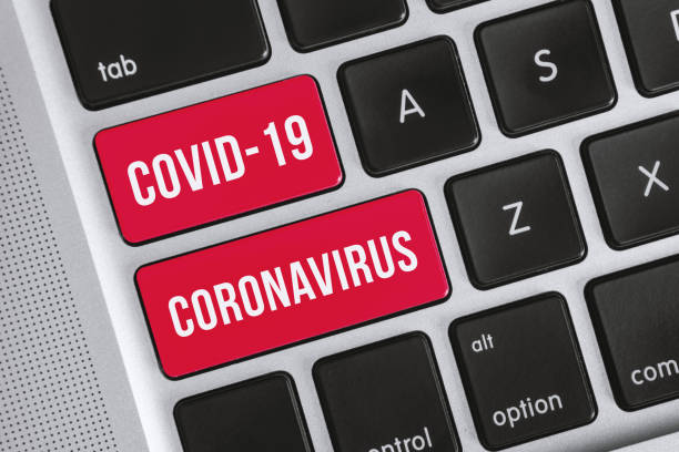 Covid-19 Coronavirus Word on Computer Keyboard stock photo