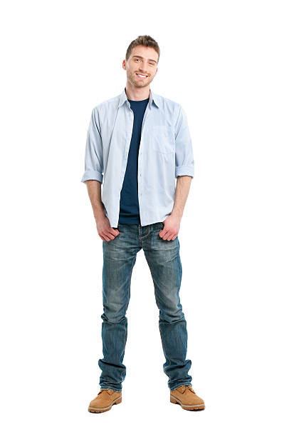 Smiling guy full length Happy smiling young man standing full length isolated on white background. hands in pockets stock pictures, royalty-free photos & images