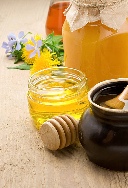 istock honey in jars and flower on wood 120908513