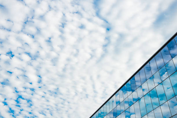 istock Abstract Background of Glass Office Building Reflecting a Cloudy Sky 1209085588