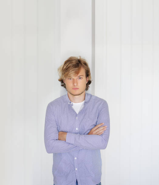 istock Teenager standing near a white wall 1209087070