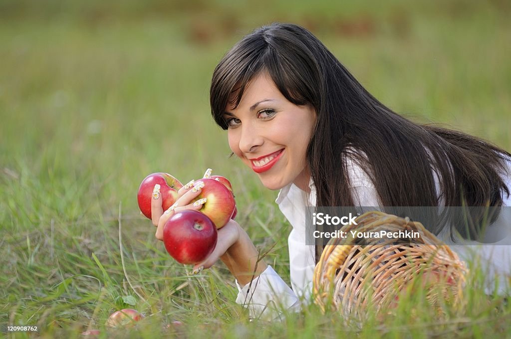 Woman with apple Woman outdoors holding an apple. 20-24 Years Stock Photo
