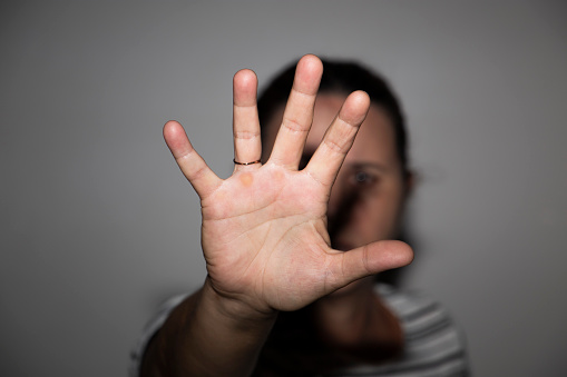 Woman's hand in front of her face