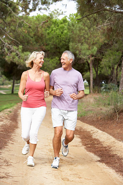 istock Senior couple running in park 120909028