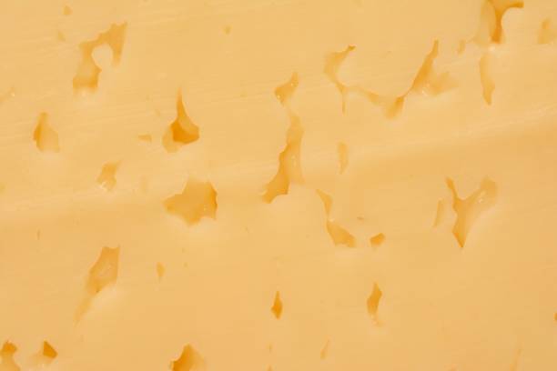 istock Cheese texture close-up on a slice of a piece 1209090936