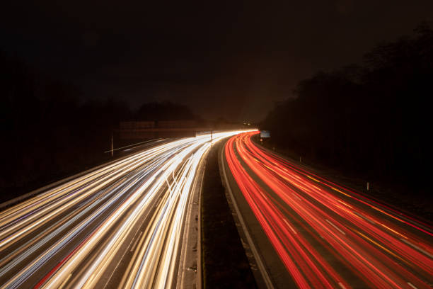 istock highway in the dark, headlight lights, long exposure lights 1209095969