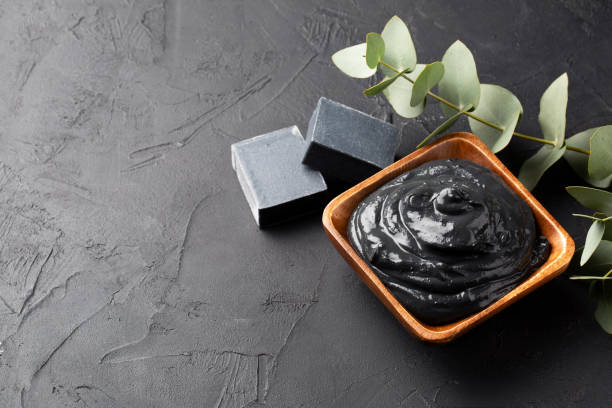 istock Spa and bath concept. Dead sea mud, coal black soap, eucalyptus on black background. Copy space. 1209096149