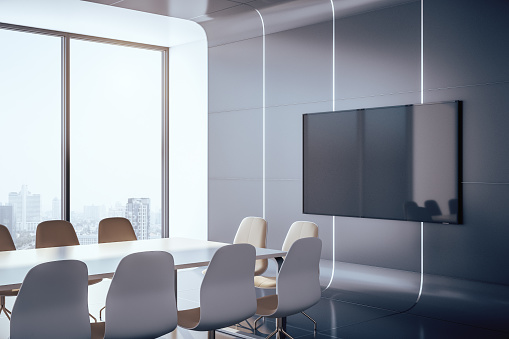 Futuristic conference interior room with blank plasma on wall and city view. Presentation concept. 3D Rendering