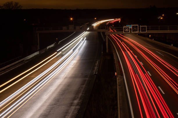 istock highway in the dark, headlight lights, long exposure lights 1209096380