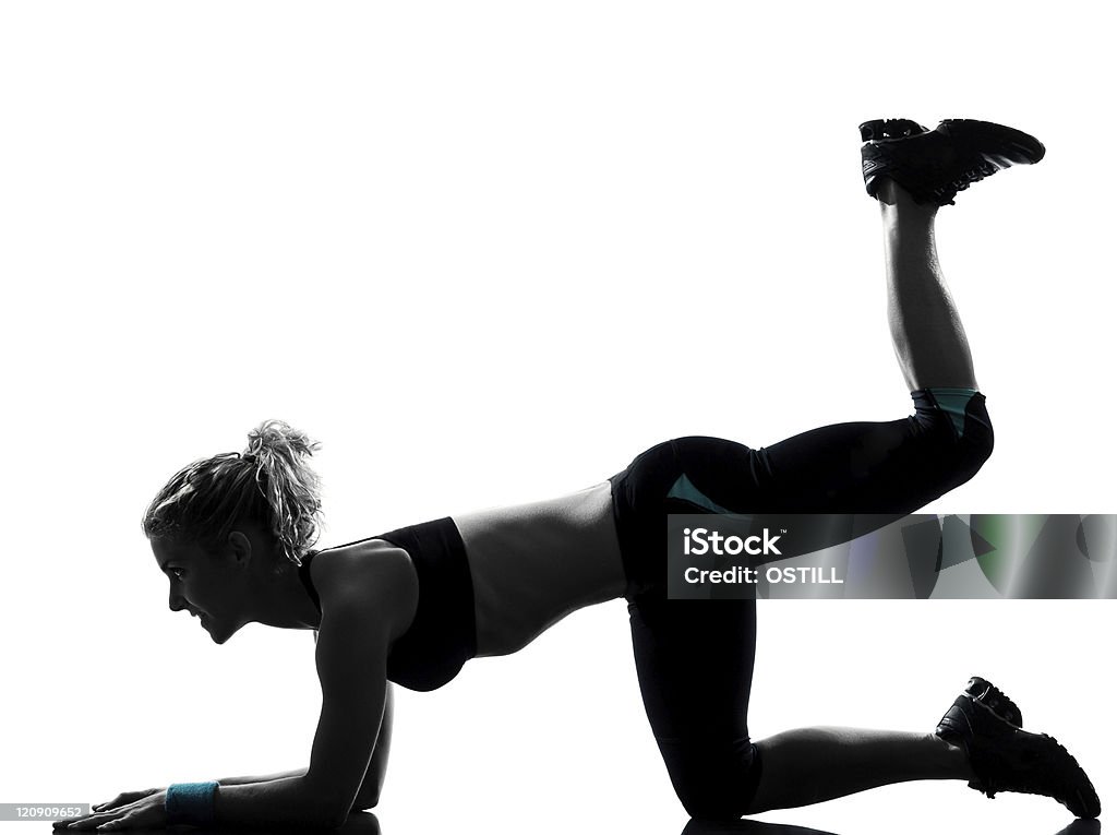 woman workout fitness posture legs feet up one woman exercising workout fitness aerobic exercise legs feet up posture  in studio isolated on white background Adult Stock Photo