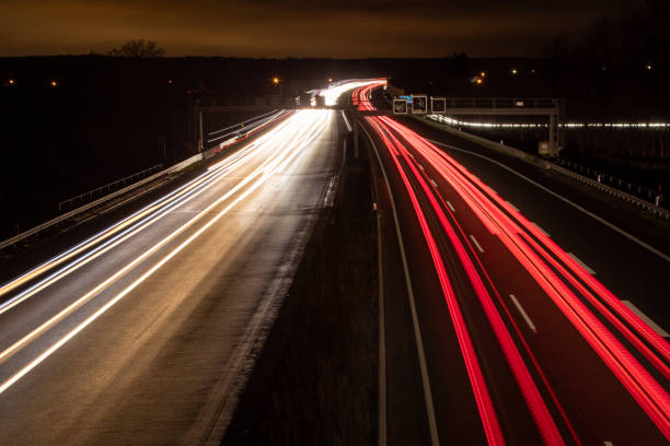 istock highway in the dark, headlight lights, long exposure lights 1209096521