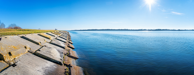 Gabcikovo Dam with bank made of concrete blocks on sunny day