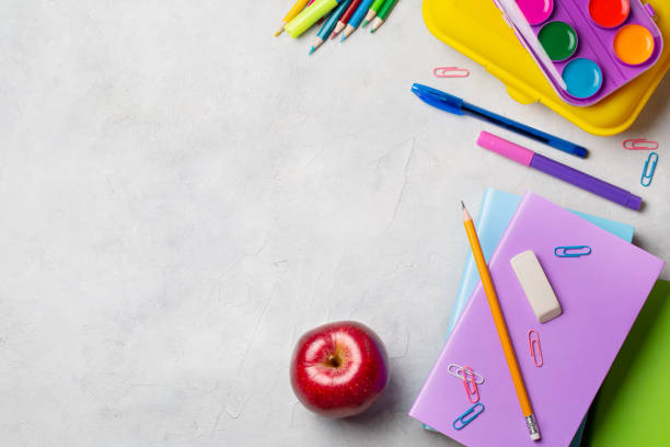 istock Back to school 1 September. School objects books, red apple, notebooks, pencils and lunch box on the table top view. 1209098798