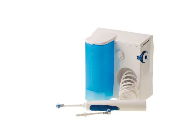 istock Water jet  irrigator cleaning system and two waterjet heads isolated on white background. Health care concept. 1209098921
