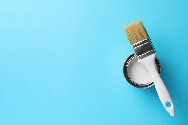 istock Paint can and brush on blue background, top view 1209105025