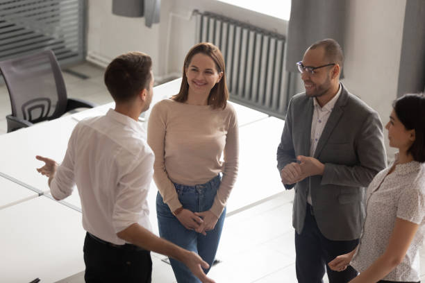 istock Confident team leader explaining work moments to employees. 1209105738