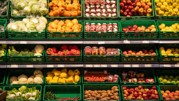 istock Various vegetables tomatoes, cucumbers, cabbage are sold at vegetable shop. Vegetables lie on shelf in grocery store. 1209105985
