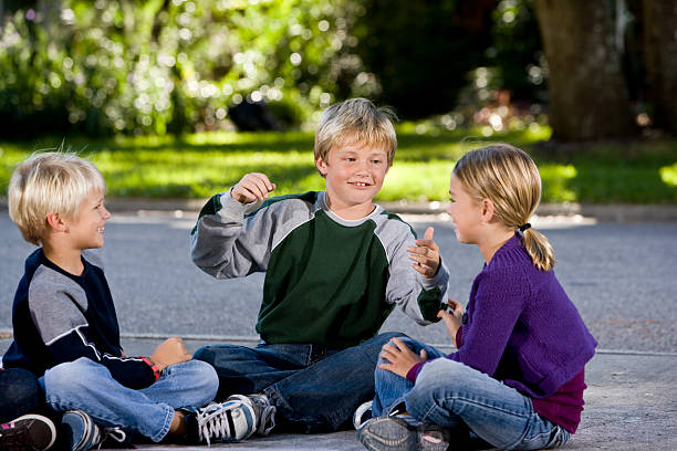 istock Children sitting and talking together on driveway 120910613