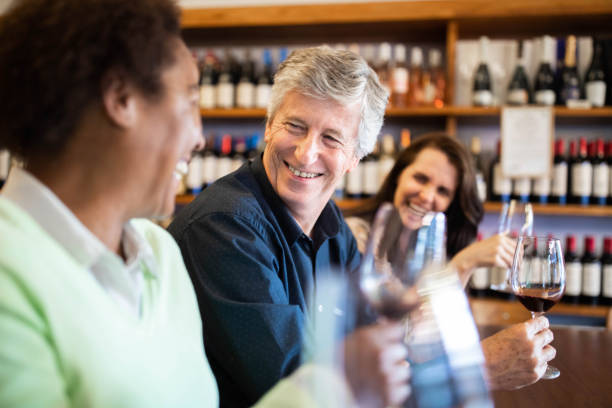 istock Smiling people in wine tasting room 1209107727